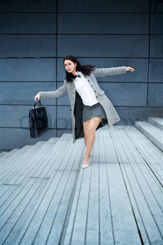 Young woman balancing on staircase, stock photo