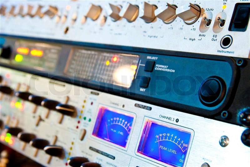 Amplifier studio equipment with knobs and lamps, stock photo