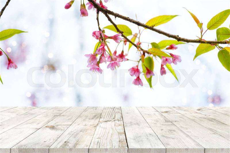 Top of wood table empty ready for your product and food display or montage with pink cherry blossom flower (sakura) on sky background in spring season, stock photo