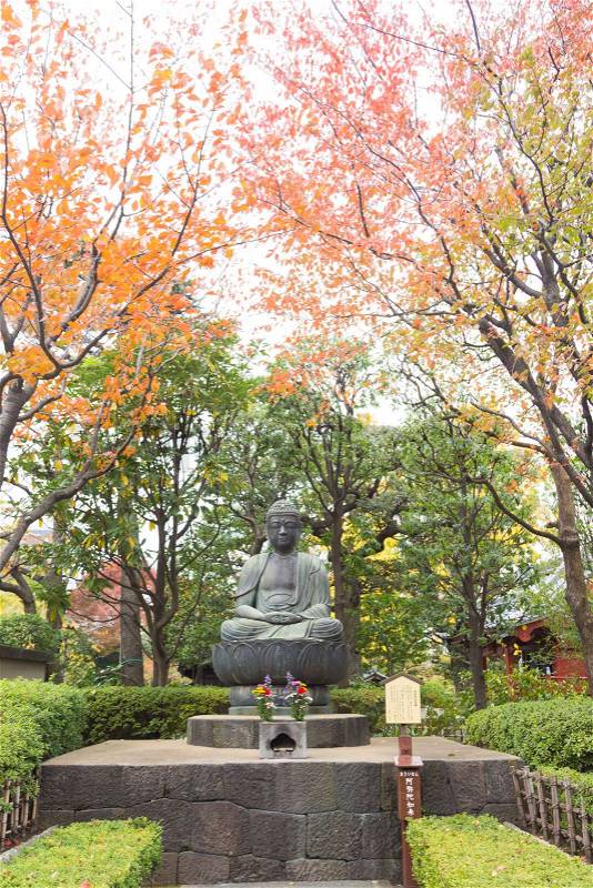 TOKYO, JAPAN - NOVEMBER 15, 2017: Buddha in the park Close to the temple with a shady atmosphere, stock photo