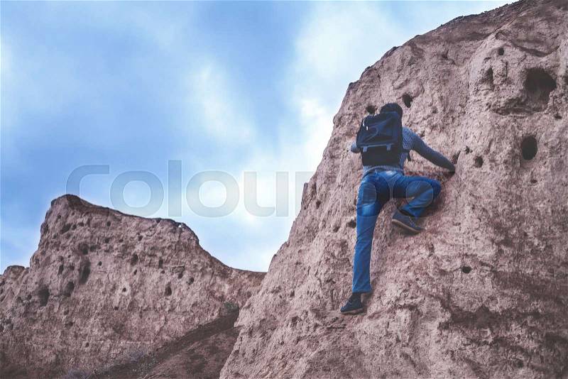 Man climbing the mountain, stock photo