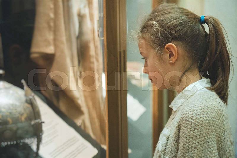 Little girl exploring expositions in museum, stock photo