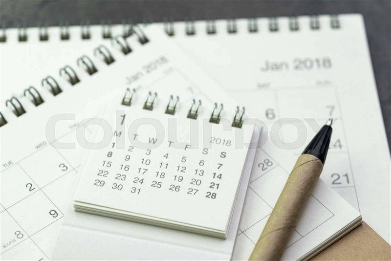 Calendar year plan or appointment reminder concept by pile of white and clean paper calendars with recycled material pen, stock photo