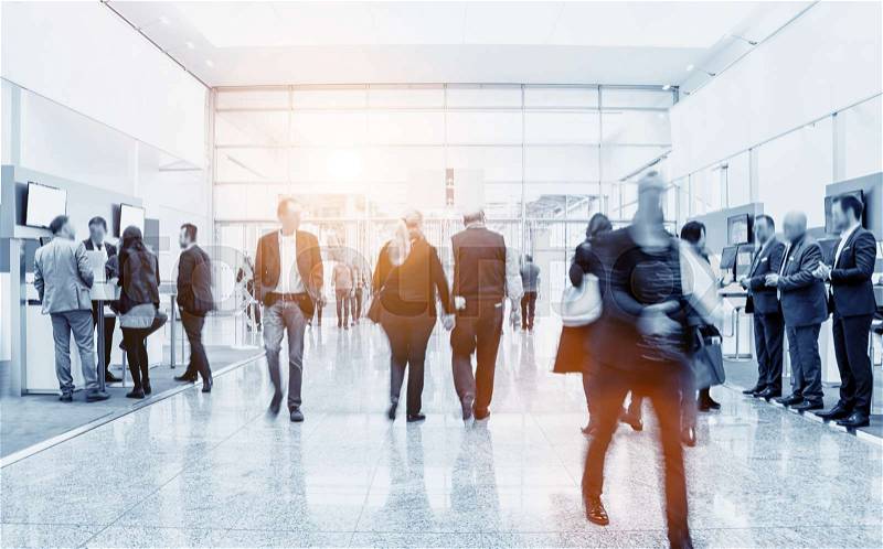 Business people crowd walking in a modern floor at a trade show. ideal for websites and magazines layouts, stock photo