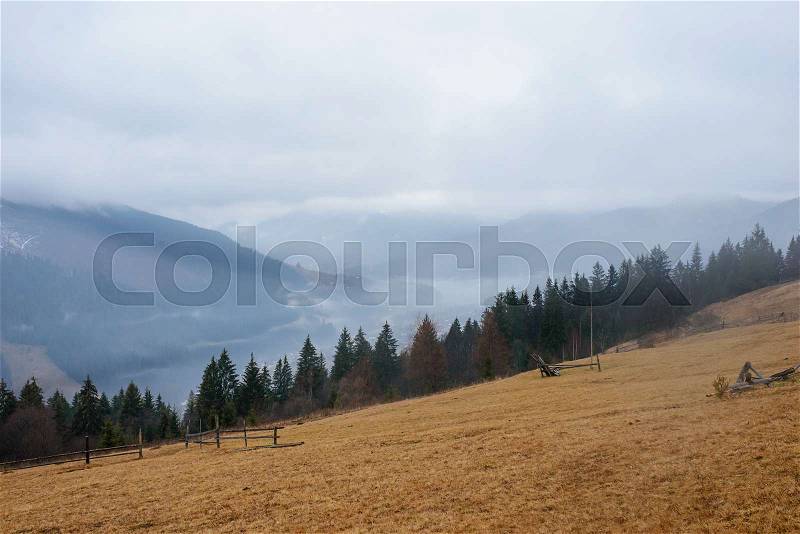 Beautiful view with morning fog in early spring, in Carpathian mountains, in Transylvania, Romania, stock photo