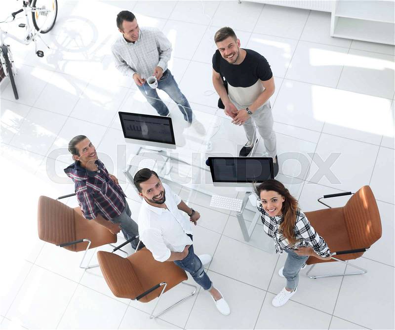 View the top employees of travel agencies standing in office and looking at camera, stock photo