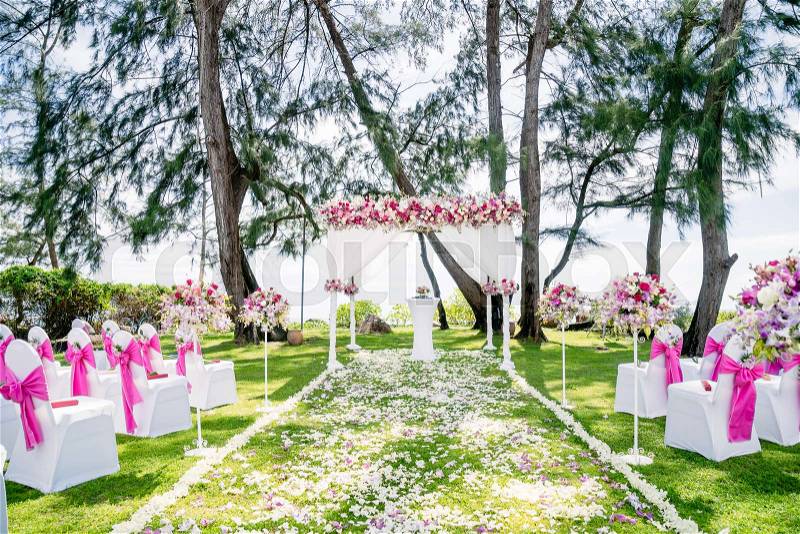 The decoration of wedding venue on the cliff with the pine tree and the ocean in the background around 5pm before the sunset, Simple but romance, at Anantara Resort & Spa in Samui island, Thailand, one of the best for destination wedding, stock photo