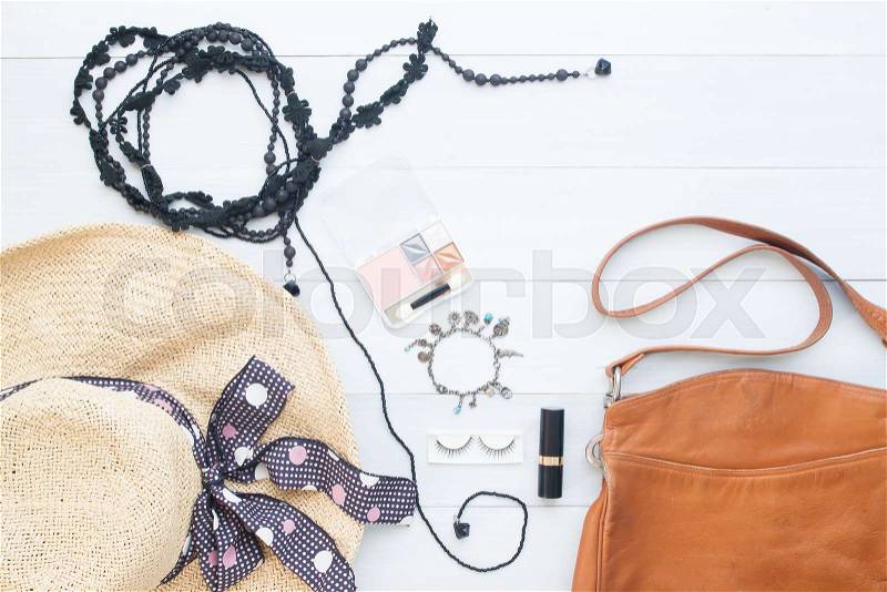 Creative flat lay of woman essentials with leather sholder bag on white vintage background, stock photo