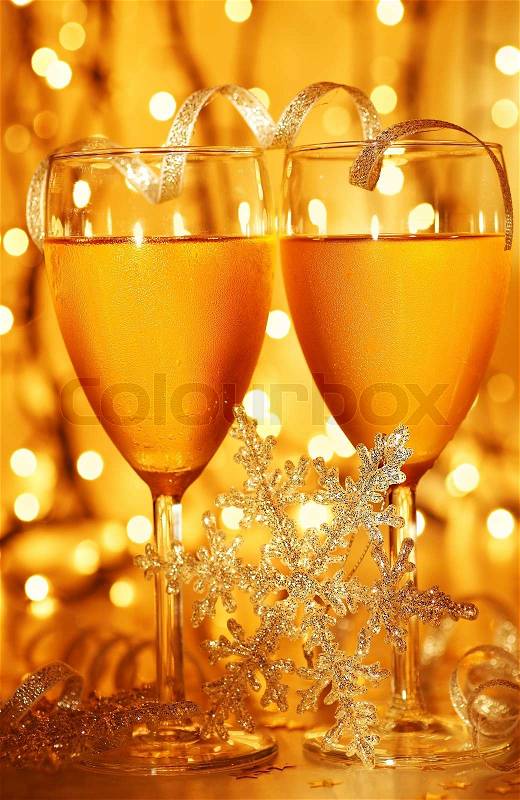 Romantic holiday dinner, celebration of Christmas or new year eve, party with Champagne and festive gold ornament decoration, stock photo