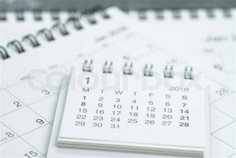 Clean white calendar business deadline, time passing, year planning or appointment reminder concept by pile of white and clean paper calendars on office table, stock photo