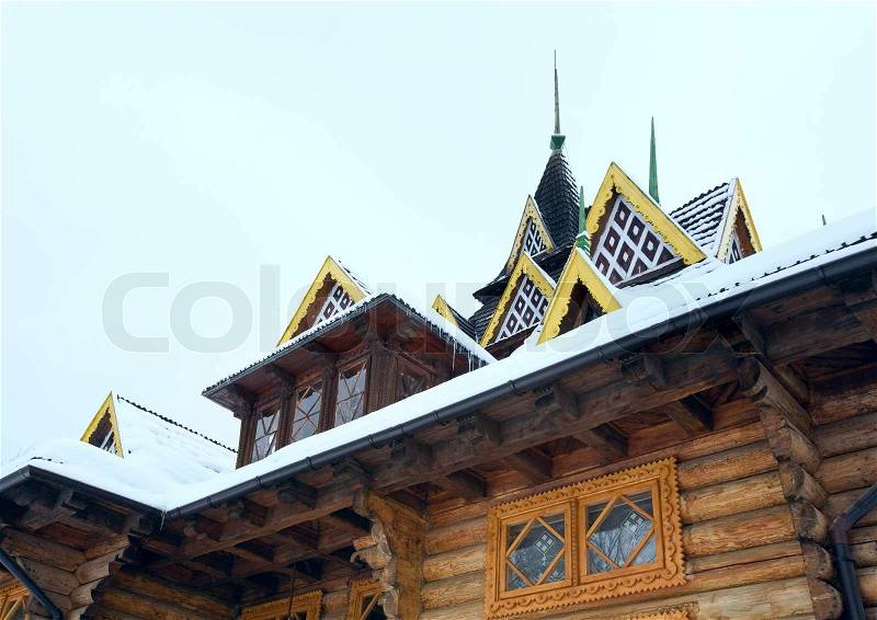 Fragment of country wooden house with snow on roof, stock photo