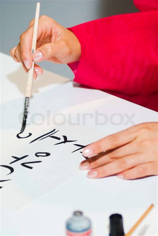 Korean girl write the word on paper close up, stock photo