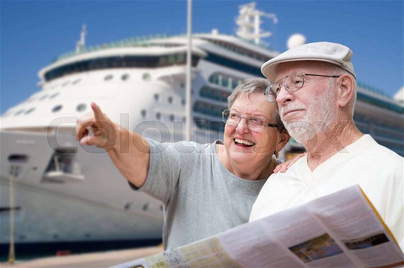 Happy Senior Adult Couple Tourists with Brochure Next To Passenger Cruise Ship, stock photo