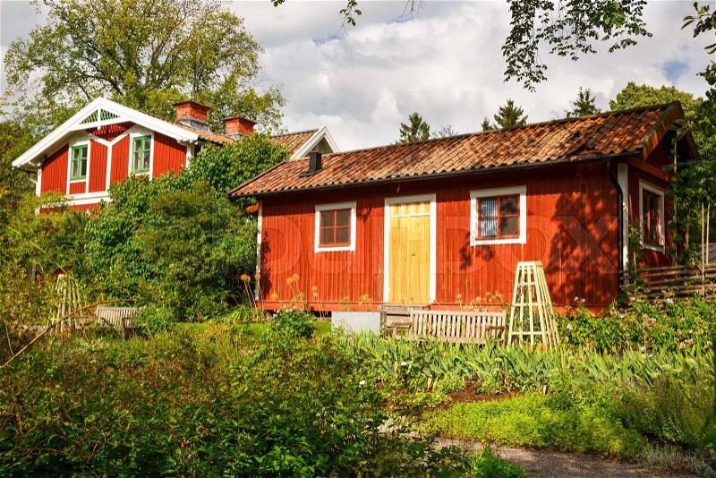 Traditional wooden houses at Skansen, the first open-air museum and zoo, located on the island Djurgarden in Stockholm, Sweden, stock photo