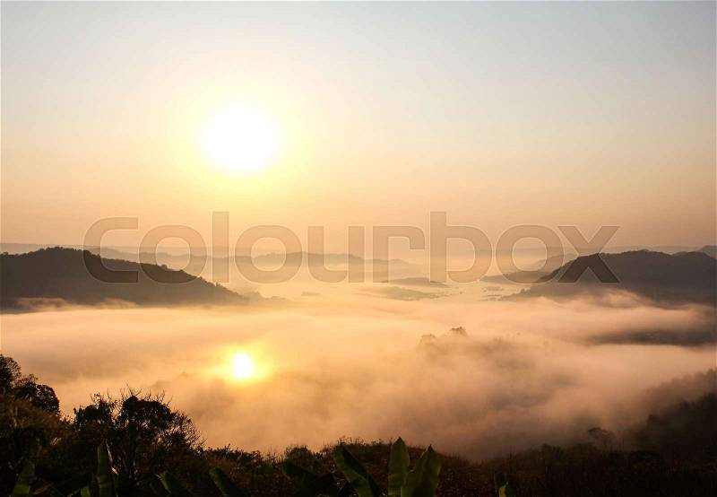 Mountains mist and sunrise view from Phu Huay Isan in Nong Khai, Thailand, stock photo