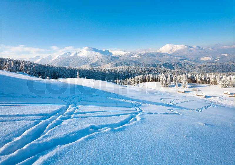 Winter calm mountain landscape with sheds group and mount ridge behind Kukol Mount, Carpathian Mountains, Ukraine, stock photo