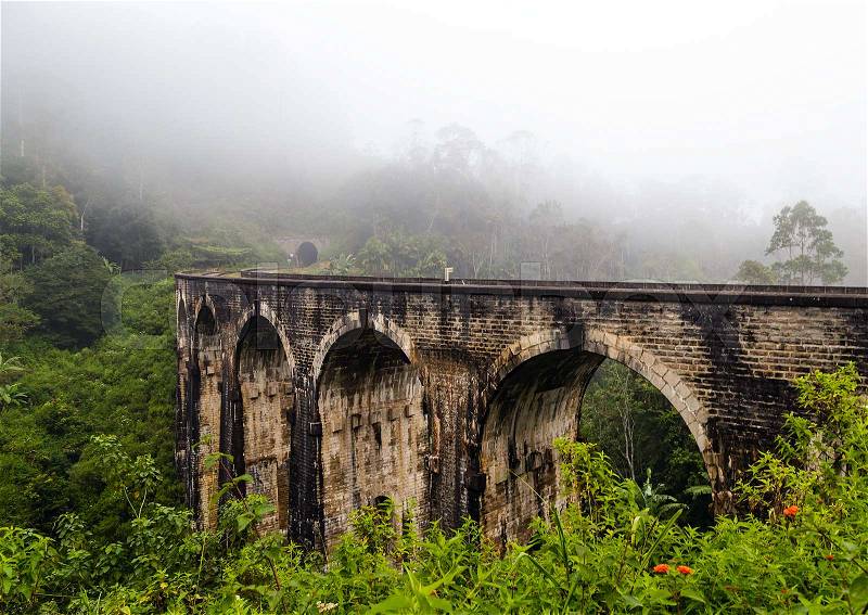 Arches Bridge in Demodara, mist morning Ella, railways Sri Lanka Mountain Palm landscape, stock photo