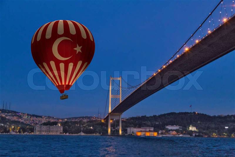 Red Hot Air balloons flying over Bosphorus Bridge at night. Istanbul, Turkey, stock photo