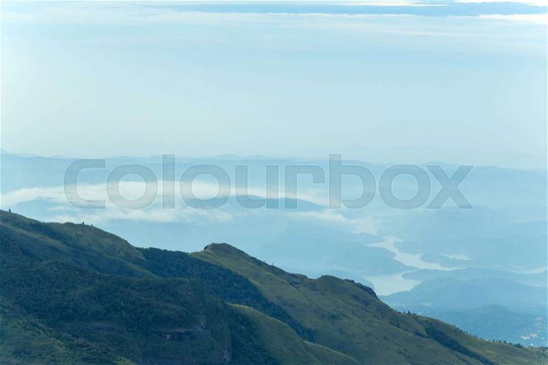 Sunrise in meadows and mountains landscape, Worlds End in Horton Plains National Park Sri Lanka, stock photo