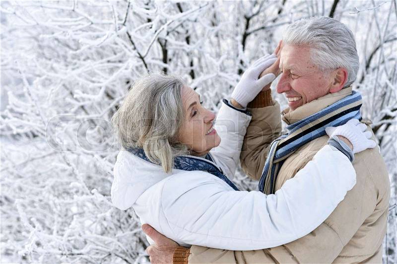 Happy senior couple dancing at winter outdoors, stock photo
