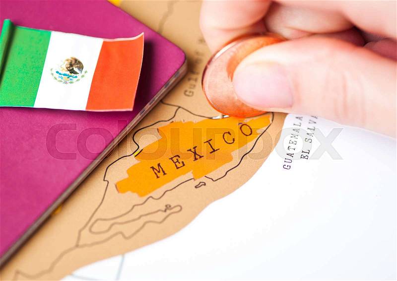 Travel holiday to Mexico concept with passport and flag with female hand choosing Mexico on the map, stock photo