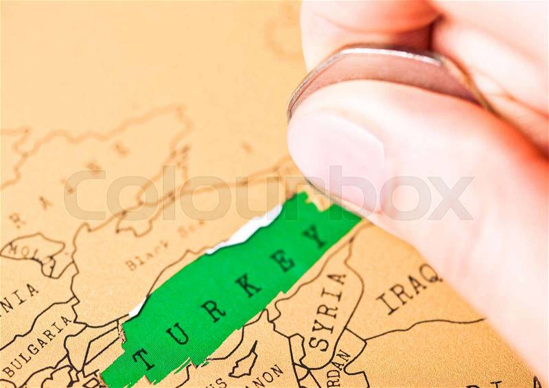 Travel holiday to Turkey concept female hand coin choosing Turkey, stock photo