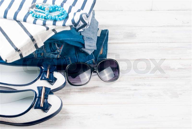 Collage of Feminine clothing and accessories in a marine style on white background. , stock photo