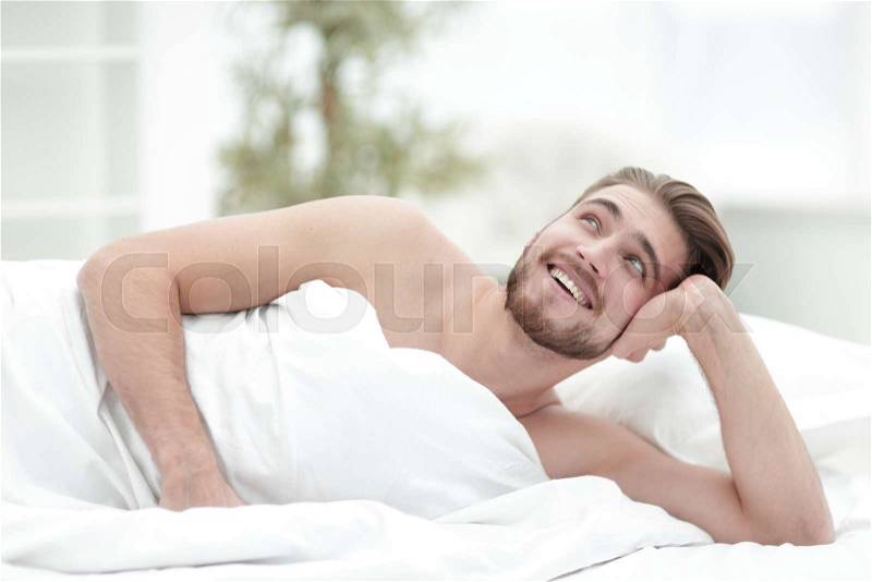 Closeup.a man dreams of lying on the bed.photo with copy space, stock photo