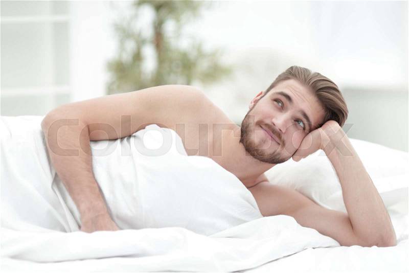 Closeup.a man dreams of lying on the bed.photo with copy space, stock photo