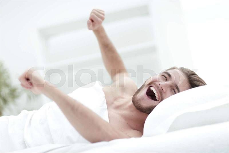 Happy man waking up in a comfortable room.photo with copy space, stock photo
