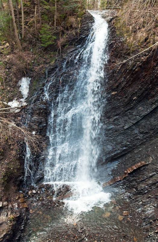 High mountain waterfall in wild Carpathian forest Guk Waterfall, Ivano-Frankivsk Region,, stock photo