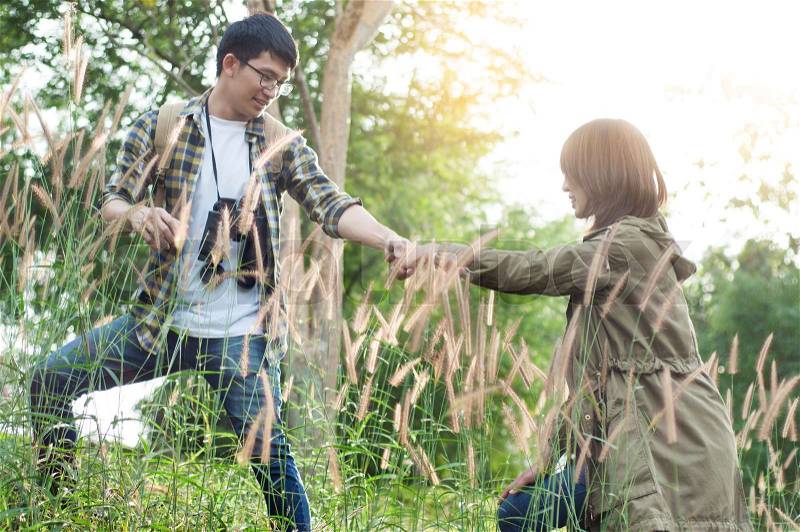 Couple of Asian tourists walking is a wild adventure, stock photo