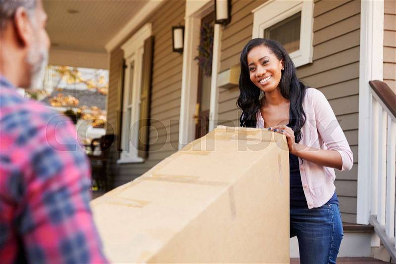 Couple Carrying Big Box Purchase Into House, stock photo