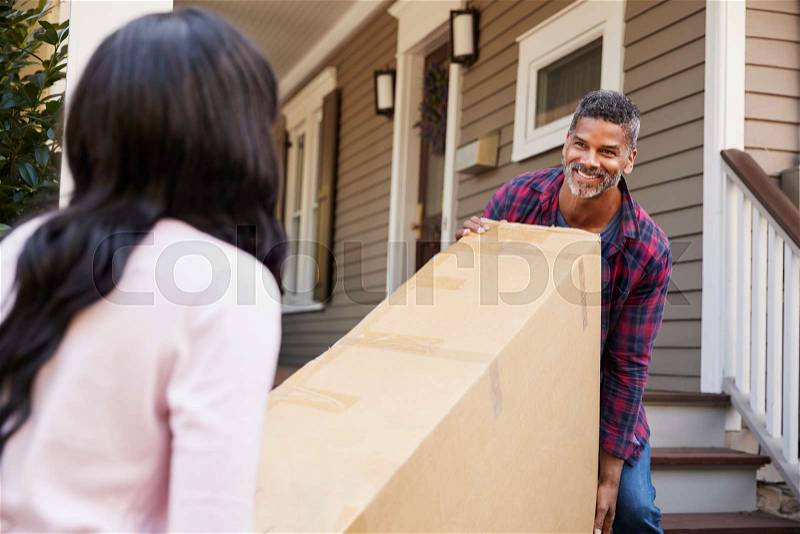 Couple Carrying Big Box Purchase Into House, stock photo