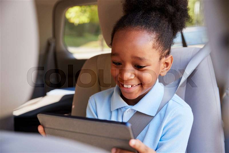 Boy Using Digital Tablet On Car Journey, stock photo