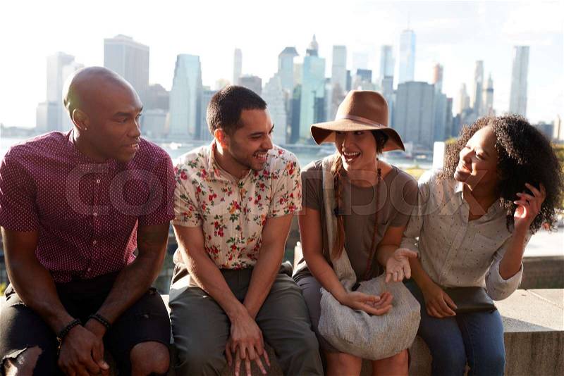 Friends Visiting New York With Manhattan Skyline In Background, stock photo