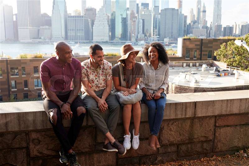Friends Visiting New York With Manhattan Skyline In Background, stock photo