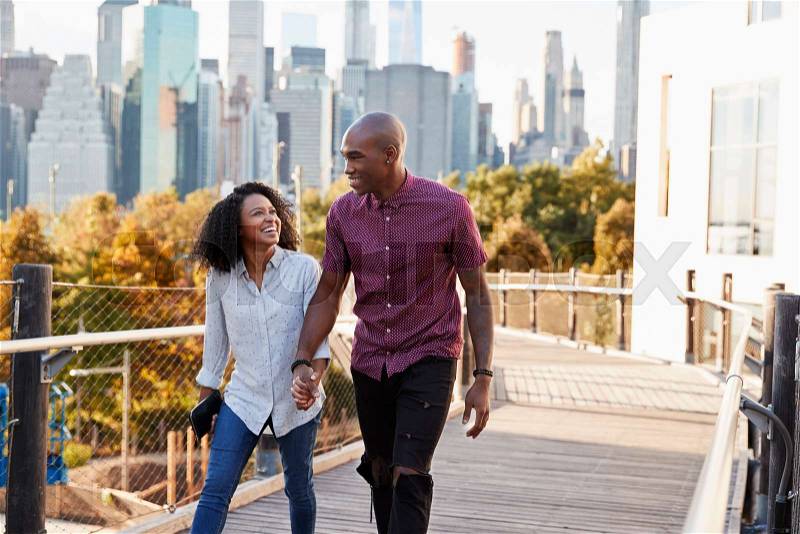 Couple Visiting New York With Manhattan Skyline In Background, stock photo