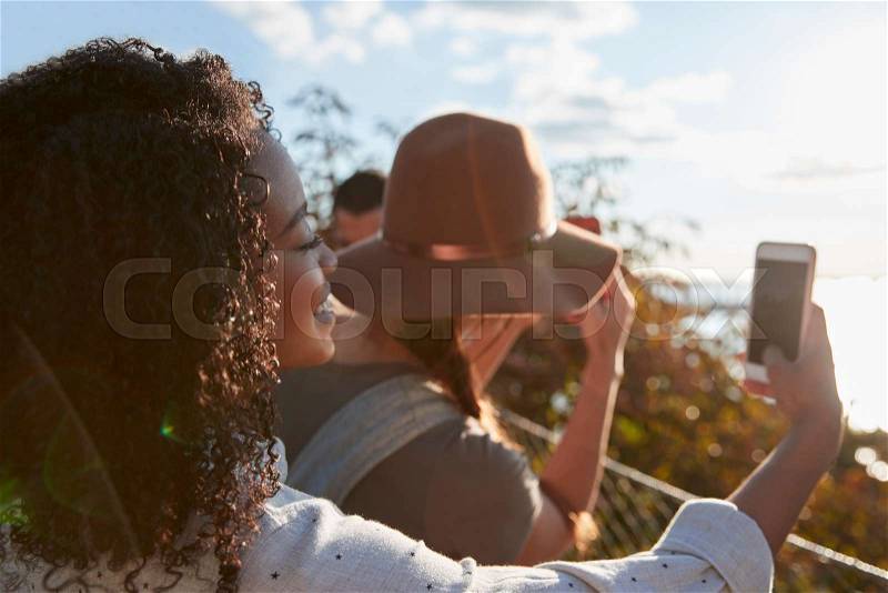 Group Of Tourists Taking Photos On Mobile Phones, stock photo