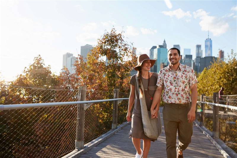 Couple Visiting New York With Manhattan Skyline In Background, stock photo