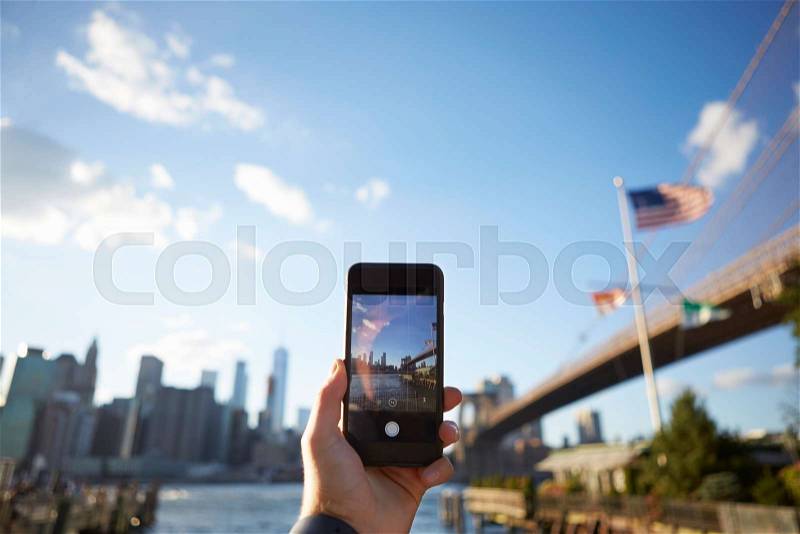 Tourist Taking Photo Of Manhattan Skyline On Mobile Phone, stock photo
