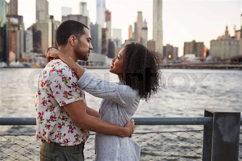 Romantic Young Couple With Manhattan Skyline In Background, stock photo