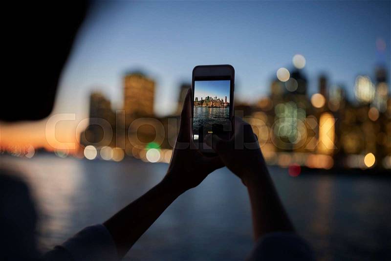 Silhouette Of Tourist Taking Photo Of Manhattan Skyline At Dusk, stock photo