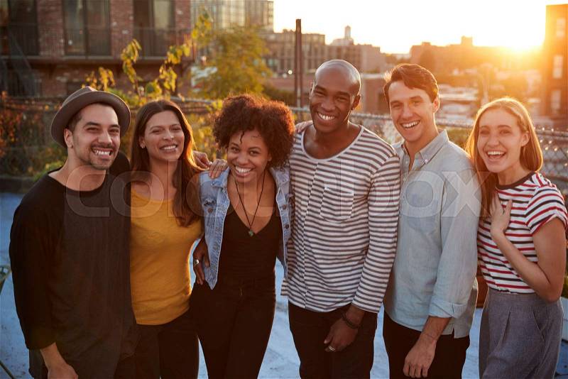 Group portrait of friends at a rooftop party in Brooklyn, stock photo