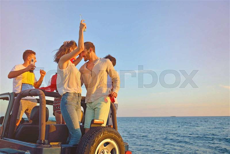 Group of happy friends making party in car - Young people having fun drinking champagne and taking photo selfie during their road trip - Friendship, party, youth addiction lifestyle concept, stock photo
