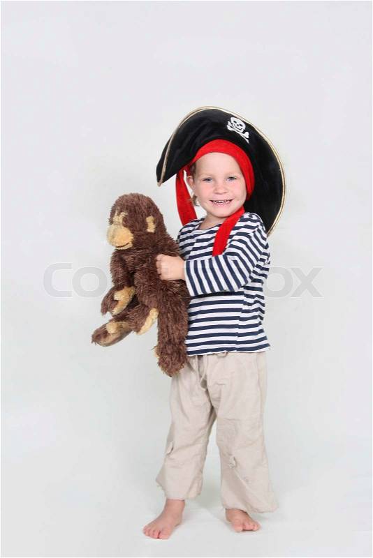 Smiling young pirate with toy monkey, stock photo
