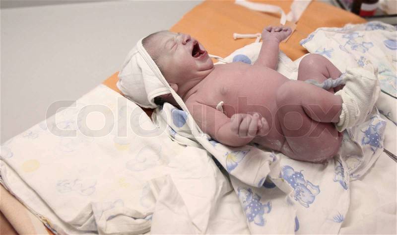 Newborn baby just after delivery, stock photo