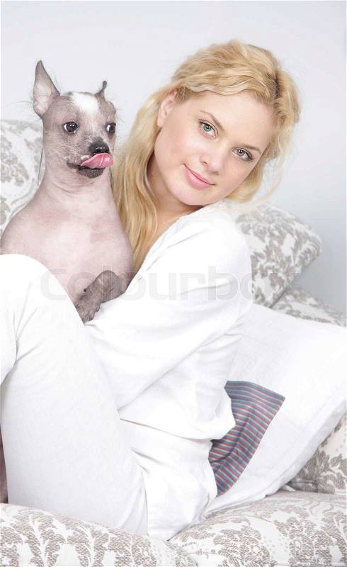 Young woman with dog at home, stock photo