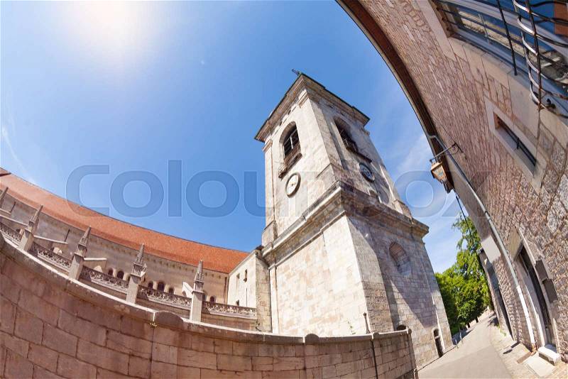 Low angle view of clock tower of Besancon St. Jean Cathedral against blue sky, France, stock photo