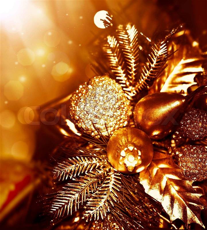 Golden Christmas tree decoration, winter holidays ornament, festive border, gold background with magic glow lights, stock photo